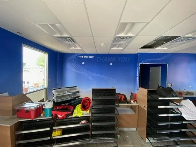 A contemporary office room with a blue wall and work tables